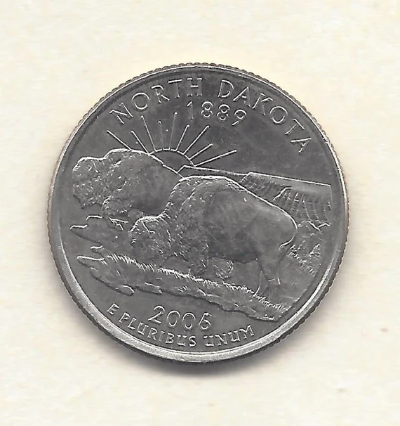 Close-up of 2006-D North Dakota quarter Five-Legged Buffalo die chip showing raised extra leg below the bison's belly