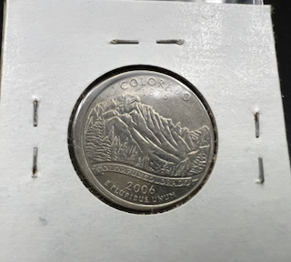 2006-P Nebraska quarter with off-center strike showing blank crescent at rim and shifted coin design